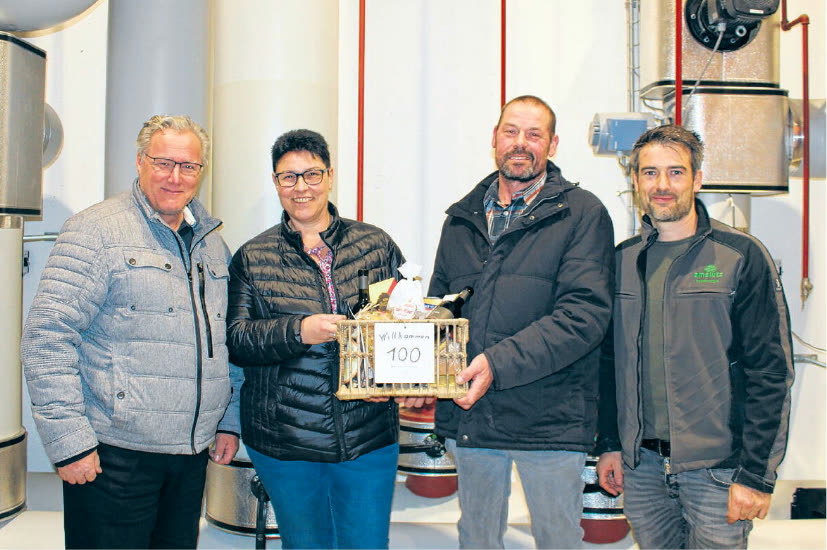Edgar Schättin, Gertrud und Urs Küttel und Raphael Schwytzer mit einem Geschenkkorb in der Heizzentrale